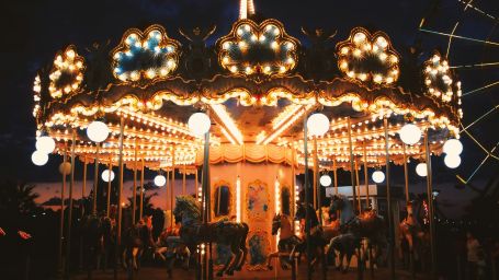 a well-lit merry go round at night