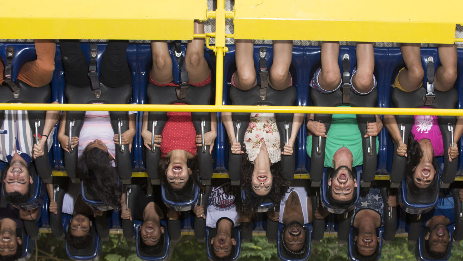 People suspended upside down while seated