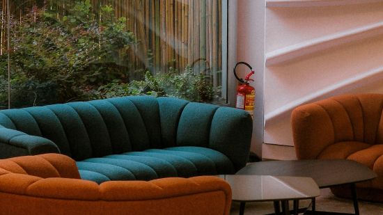 Shot of two comfortable sofas along wit a tea table.