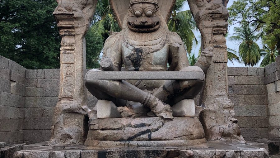 A statue of Narasimha in an old stone ruin