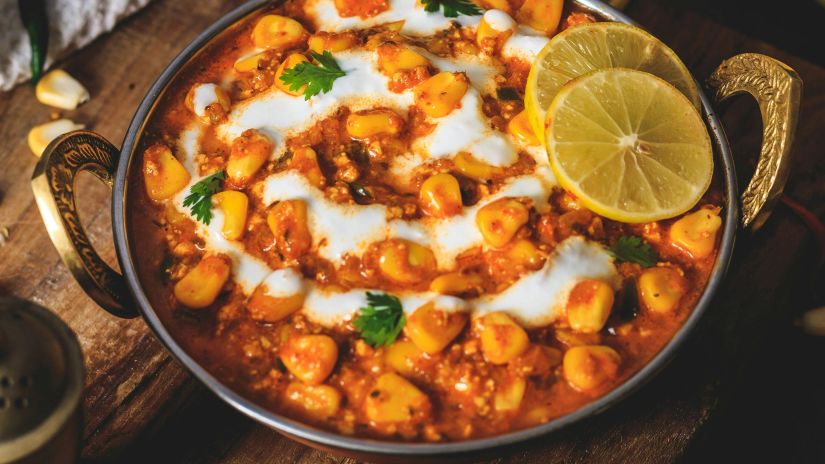 Indian gravy topped with curd and coriander