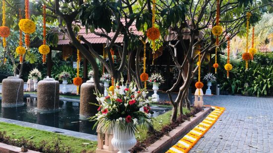 One of the open-air venues at Ananta spa & resort fully decked up with chairs, tables and a projector screen for events in pushkar 