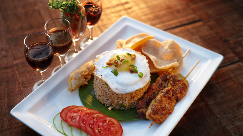 Plate of food and red wine glasses at Hablis Hotel, Chennai