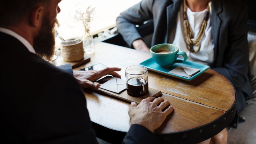 man and woman having coffee together