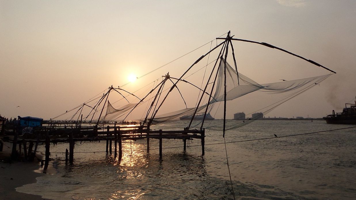 Fort Kochi Beach Chinese fishing nets being used during sunset to catch fish