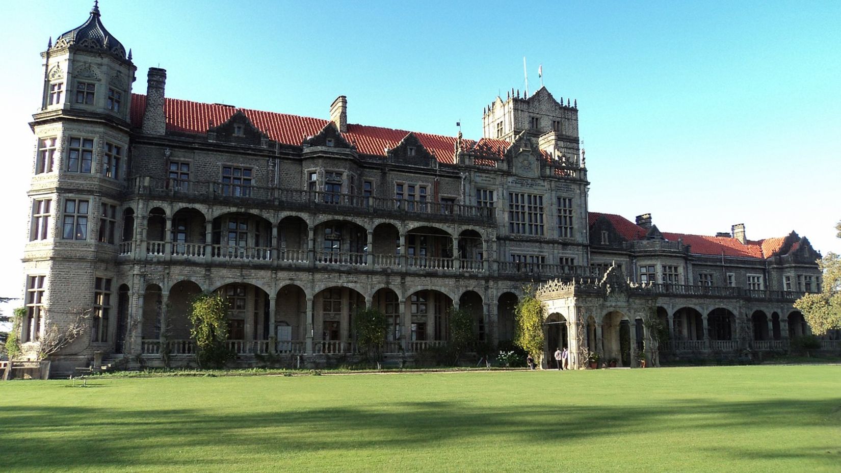 A historical building with a well maintained lawn