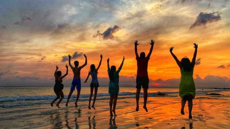 a family playing on a beach