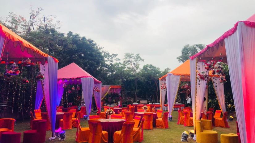 One of the open-air venues at Ananta spa & resort fully decked up with chairs, tables and a projector screen for events in pushkar 56