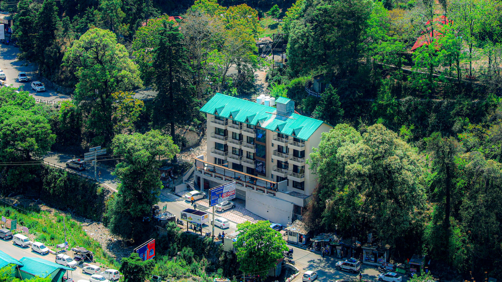 Outdoor view of Vinsober Monal, Nainital, nestled amidst a verdant embrace of lush green trees               