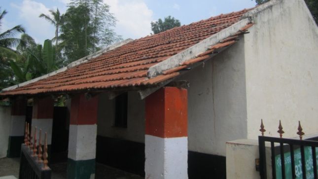 dull white building with tricolour pillars