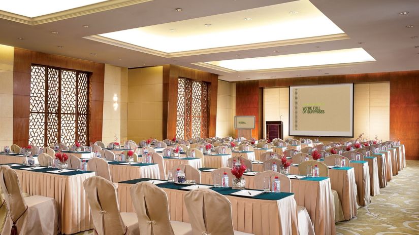 a meeting room with beige chairs and table