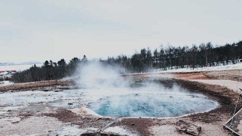 Image of a hot water spring with trees in the background