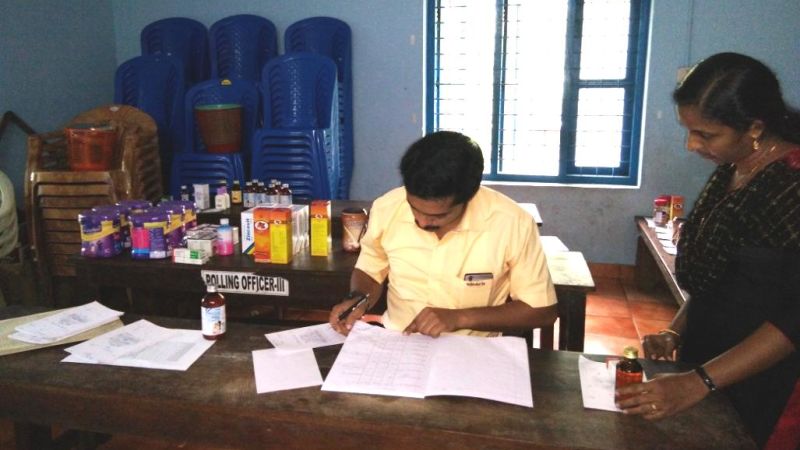 Man going through papers while a woman watches