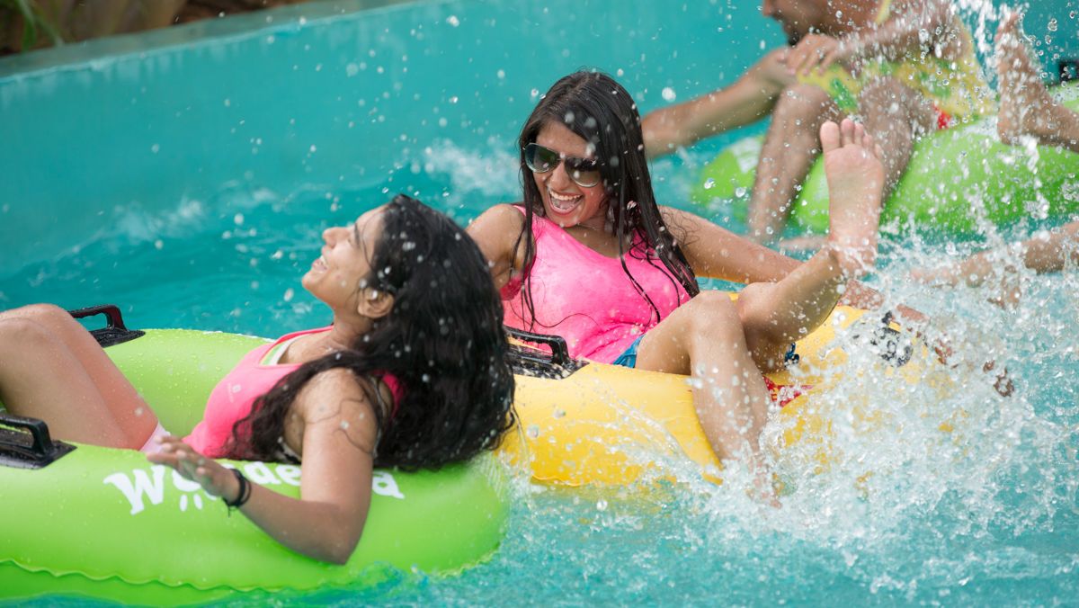 Women splashing water and enjoying as they float