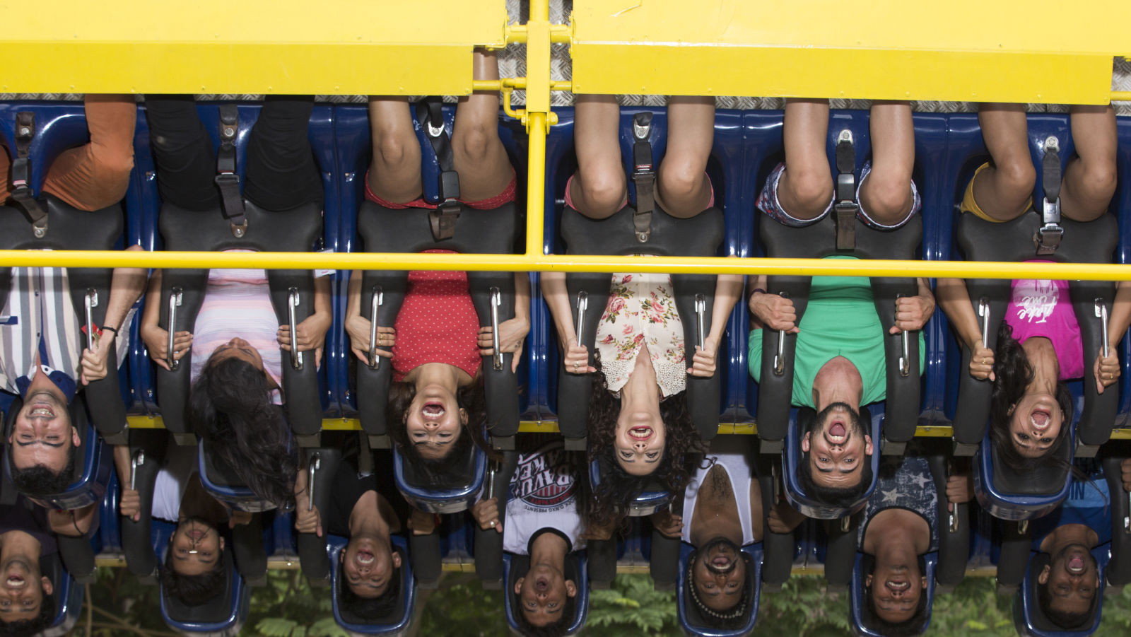 People suspended upside down while seated