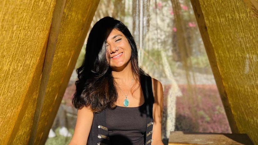 Zohra Shakti sitting in front of her cards in a tent