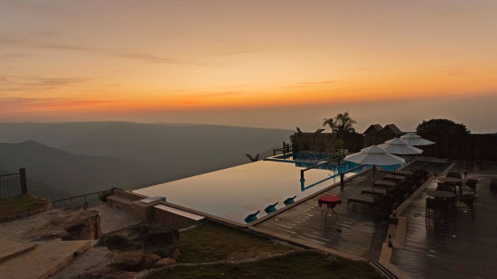 view of infinity pool during evening 11