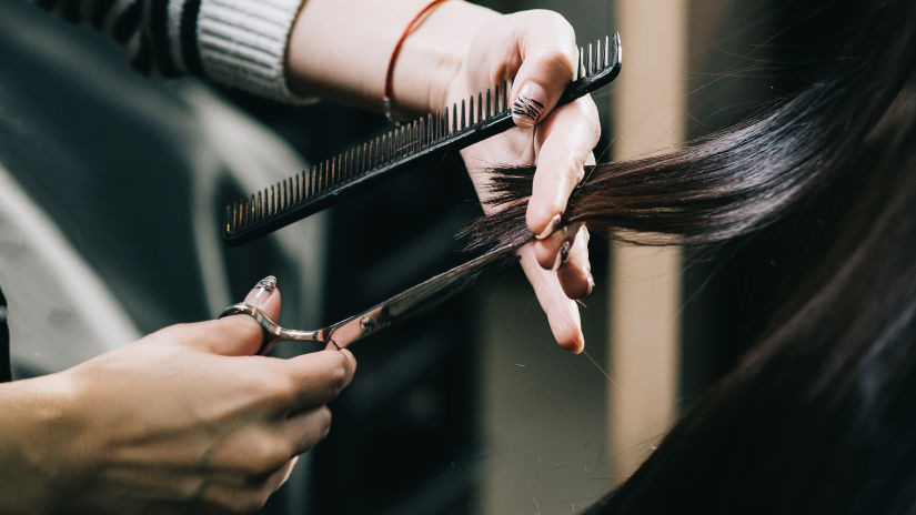 Image of a woman getting a haircut by a stylist