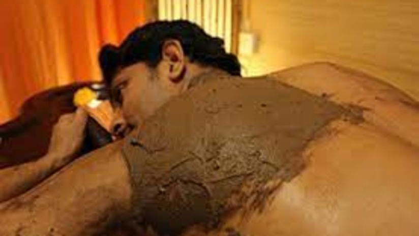 Man covered in a soil pack