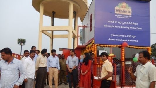 People standing below a water tank