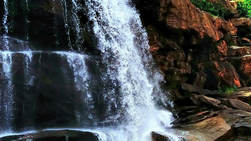 A close view of the waterfall with stone around.