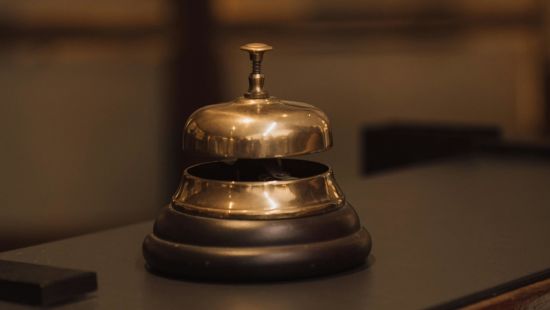 A bell placed on the front desk of a hotel