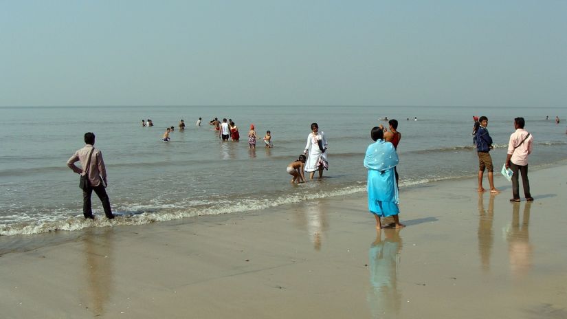 People standing near the shore on Juhu Beach