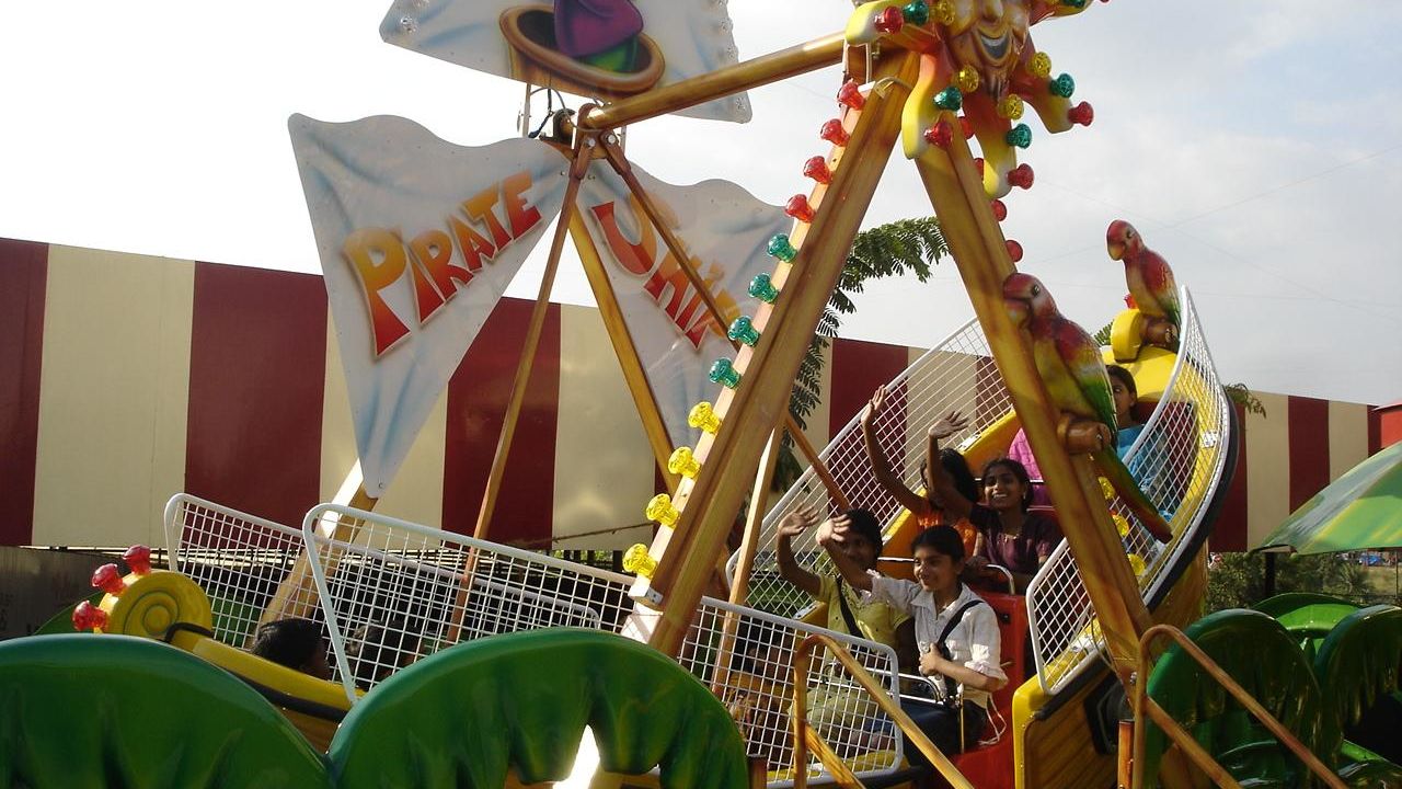 Kids riding a swinging boat ride