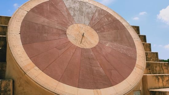 a red stone structure at Jantar Mantar in Jaipur