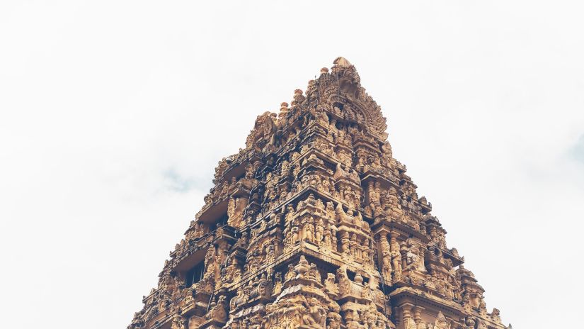 an old temple facade with intricate carvings on the roof of idols