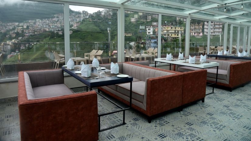 The seating arrangement in The House of Glass, a rooftop restaurant in Shimla - The Orchid Hotel Shimla