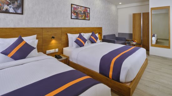 Double twin beds with paintings over the wall in executive suite  - Comfort Inn Statue Of Unity Ekta Nagar