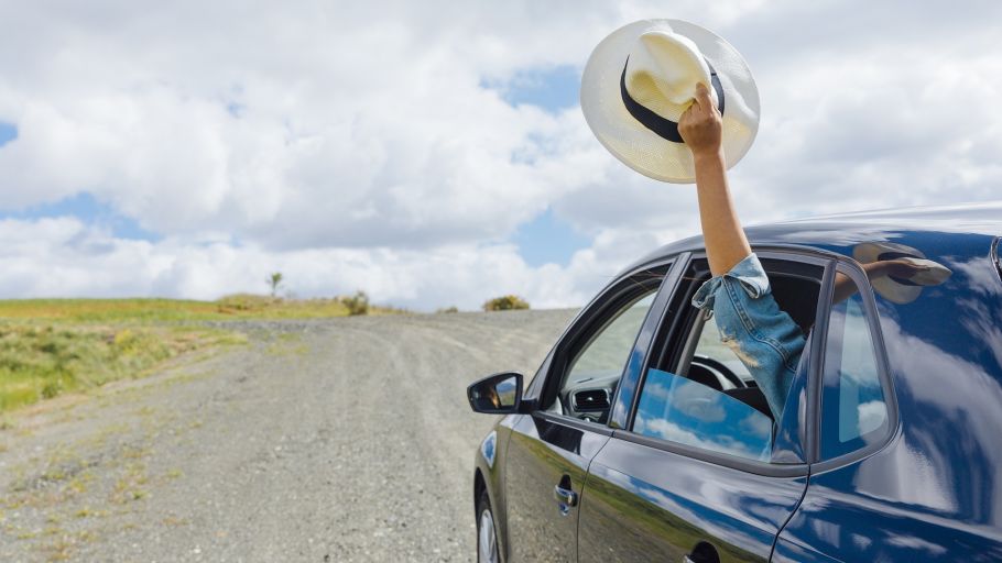 A car driving in empty roads under clear skies