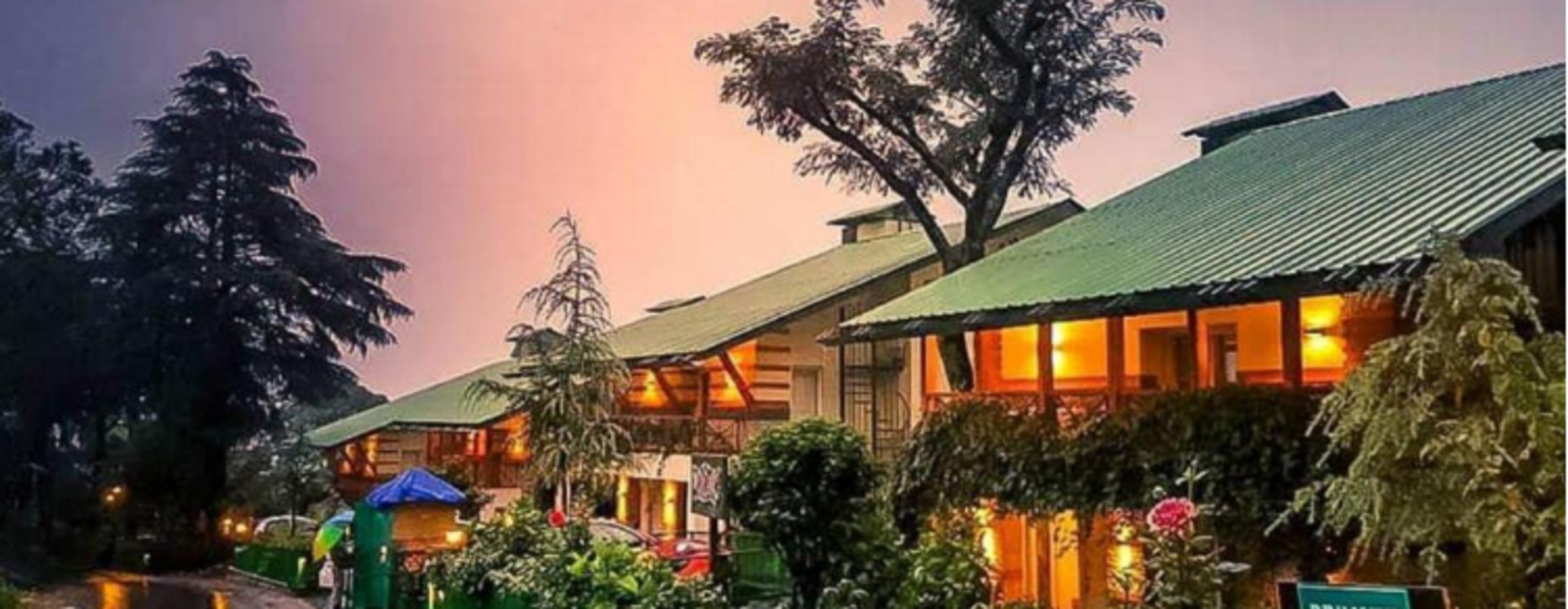 An enchanting exterior of our hotel decorated with aesthetic yellow lights and captured during sunset - Lamrin Norwood Green, Palampur2