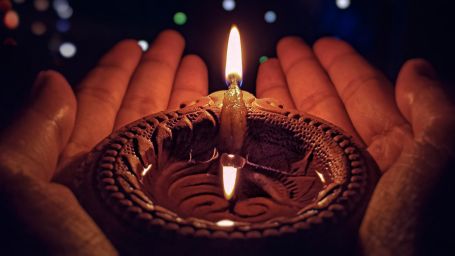 A diya being held 2