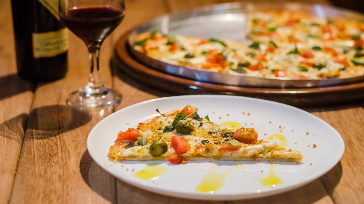 Image of a pizza slice kept in a white plate