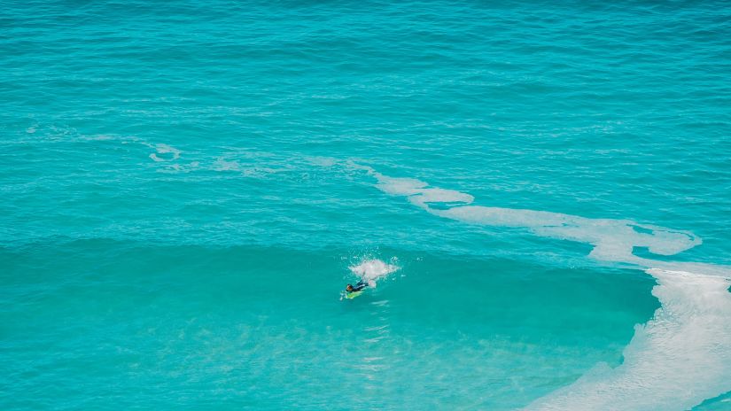 body boarding amidst the turquoise blue water