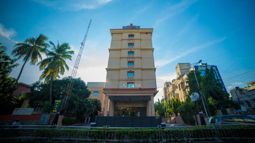 facade view of Raj Park Hotel in Alwarpet with blue sky in the background