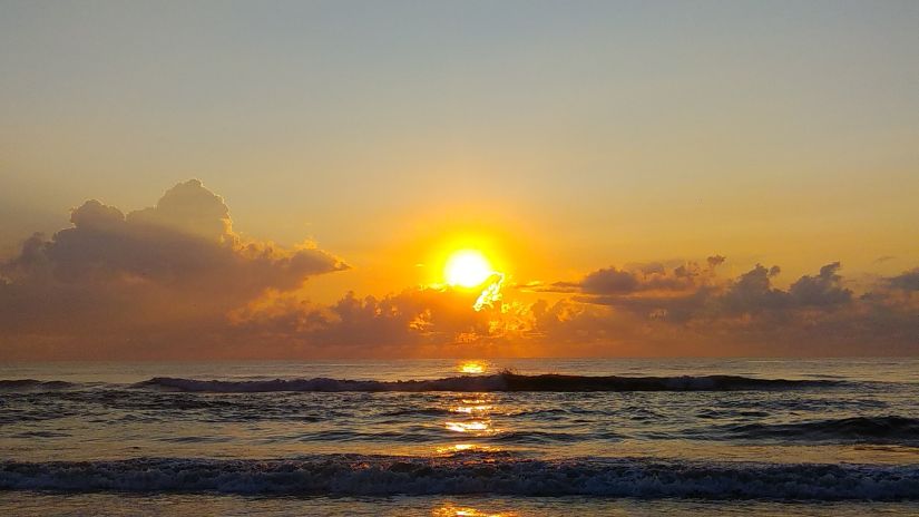 Sunrise in Marina Beach with waves overlapping on the sand