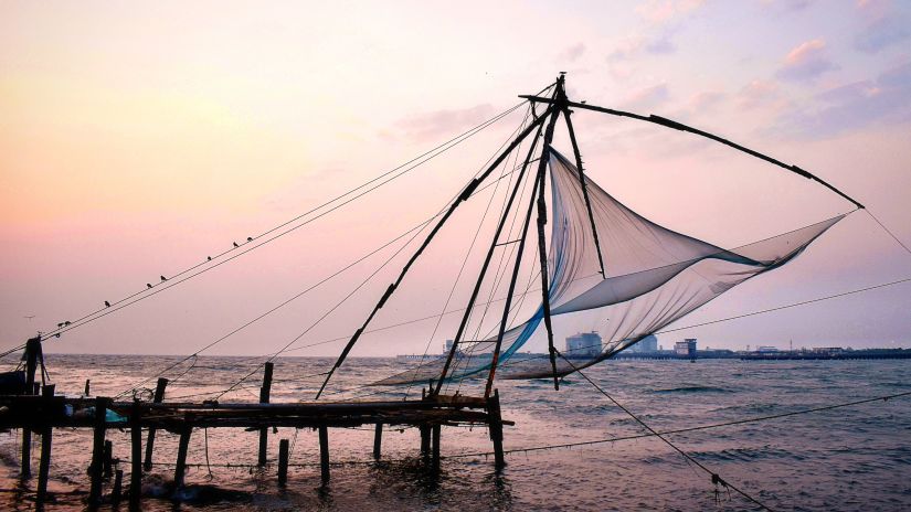 a Chinese finishing net being hung on the boardwalk with the evening sky in the background
