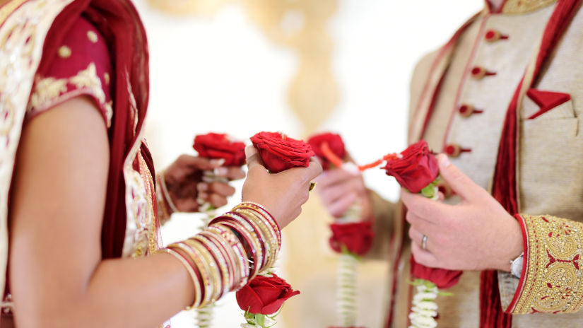 bride and groom with the garlands in their hands