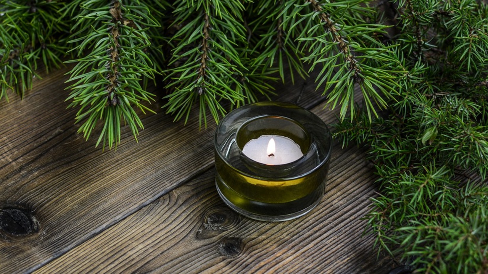 An image of the candle beside the Christmas tree.