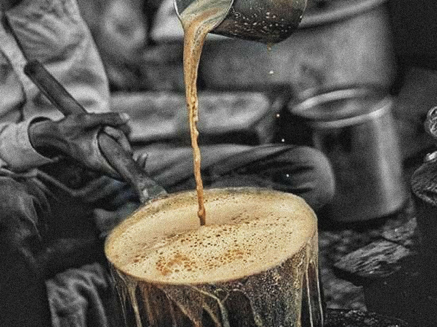 alt-text a man pouring cutting chai in a vessel