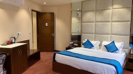 Side angle view of the room with plush bed with bedside tables - Mastiff Hotel, Dalhousie