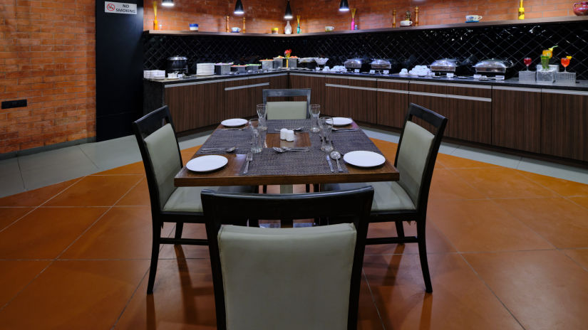 Pride Biznotel Manjusar - restaurant at our hotel with wooden floor and aesthetic interior