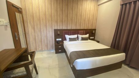 Studio room with comfy bed and a study table at Hotel Mumbai House, Indore