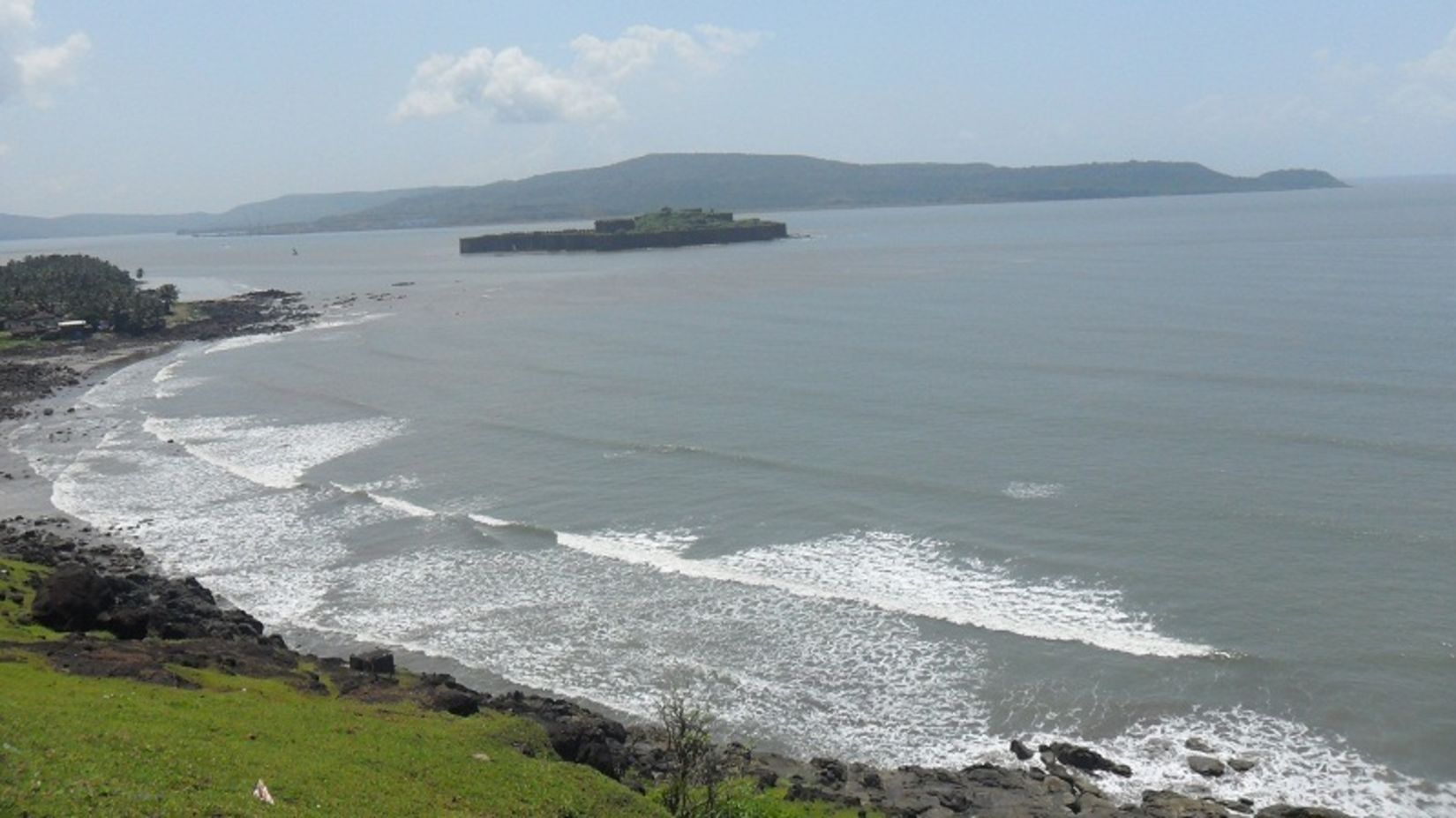 A scenic view of the Murud beach with greenery on one side