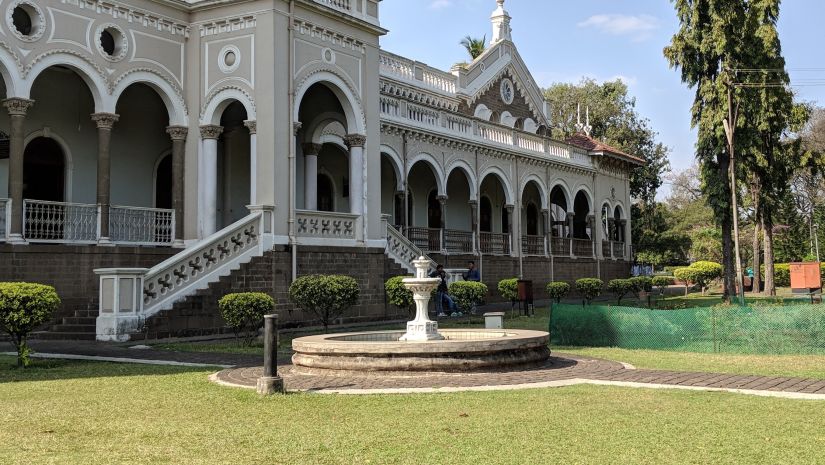 An image of Aga Khan Palace capturing the lush gardens and intricately designed building -Fort JadhavGADH 