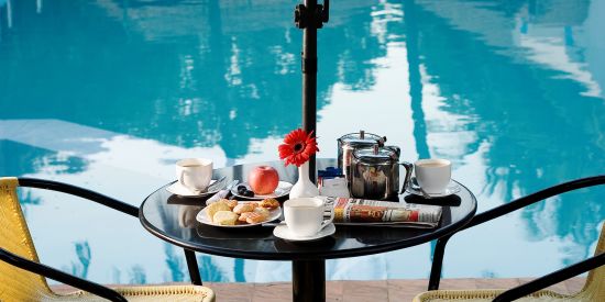 alt-text Ramanashree California Resort - view of a coffee table facing the swimming pool