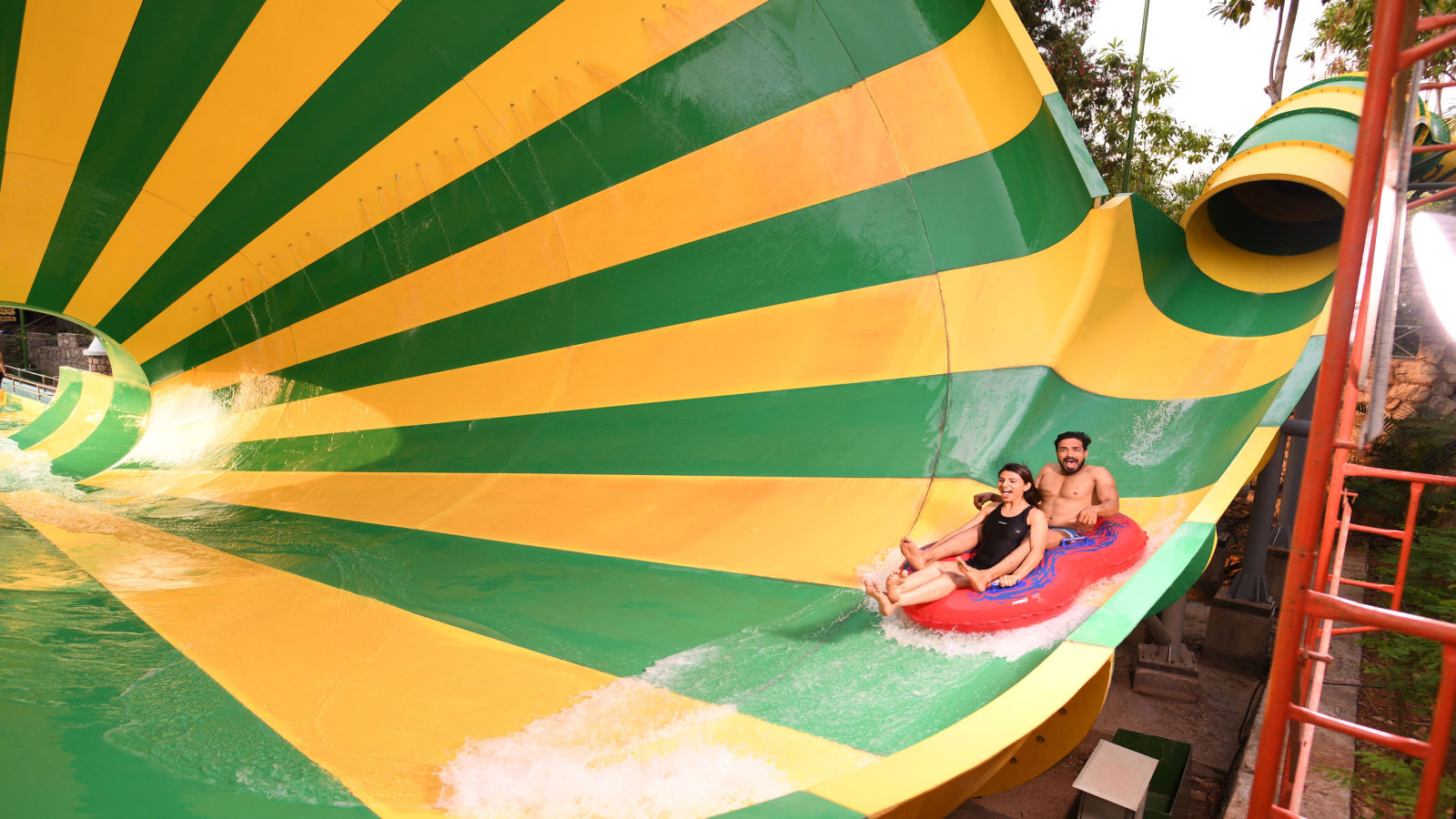 Man and woman about to enter a spiral water slide